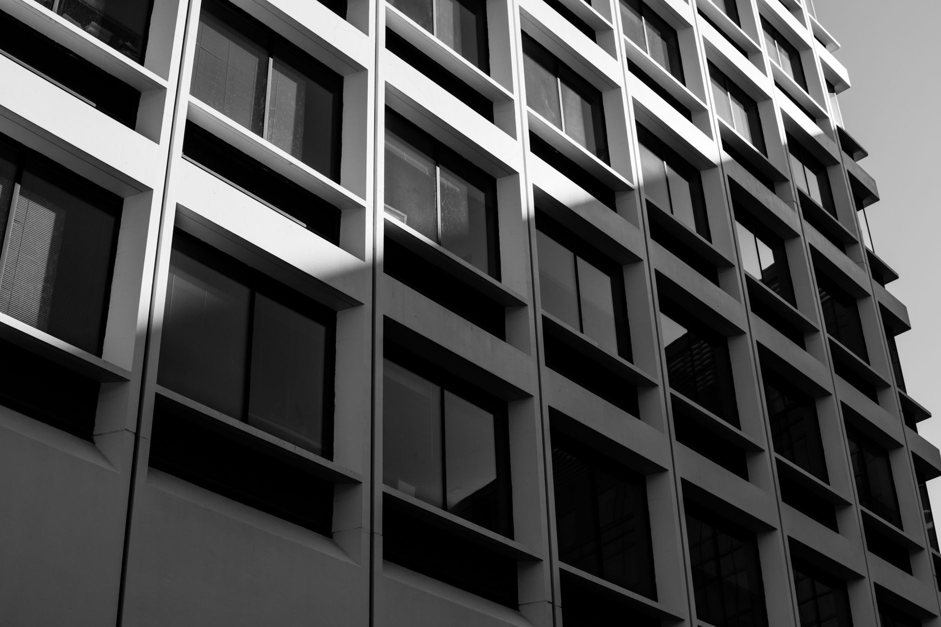 Grayscale photo of a modern building exterior in Boston, capturing geometric patterns and shadows.